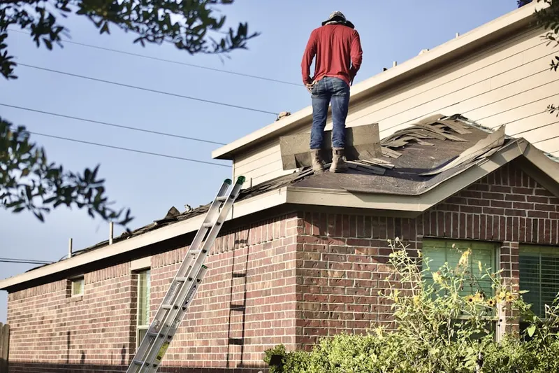 Professional roofer working on a residential roof in Switchyard Junction